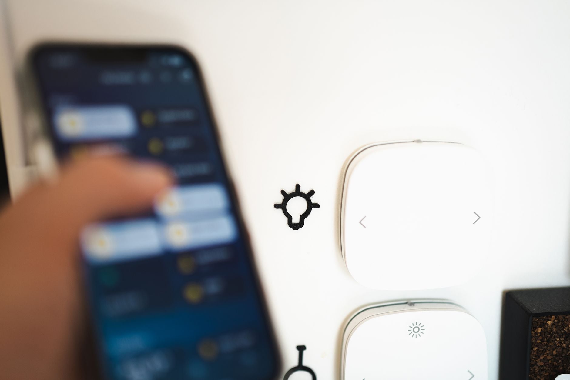 Osoba konfiguruje inteligentny system domowy za pomocą aplikacji mobilnej na smartfonie